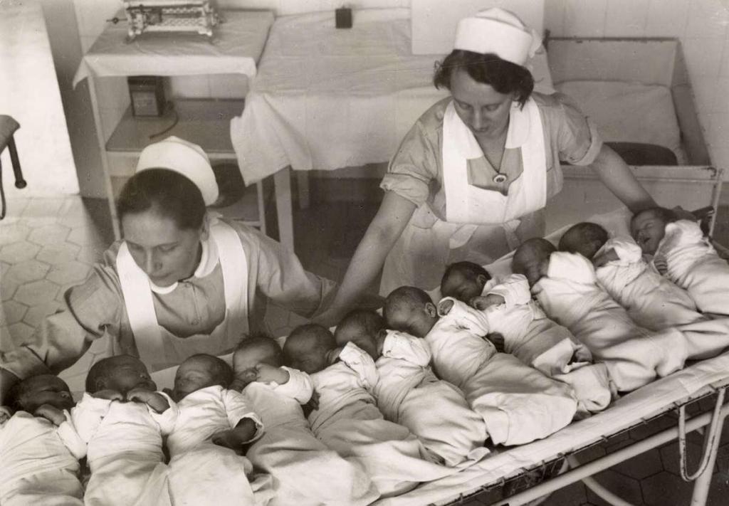 Nurses showing the eleven babies that were born on New Year’s Day 1933 in a hospital in Berlin, Germany
